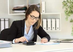 Experienced bookkeeper calculating finances in an office – 6 qualities of an experienced bookkeeper